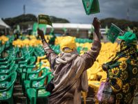 Supporters of Zanzibar incumbent President Hussein Ali Mwinyi of the ruling Chama Cha Mapinduzi (Revolutionary Party) wave flags during the campaign closing rally in Stone Town, on October 26, 2025. (Photo by MARCO LONGARI / AFP) Tanzania protests