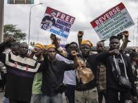 Protesters gesture while carrying placards during an anti government demonstration in Lagos, on October 1, 2024. AFP Nigerian security forces clash with protesters demanding release of separatist leader