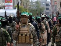 Palestinian fighters from the Ezzedine al-Qassam Brigades, the armed wing of Hamas, take part in the funeral procession of Marwan Issa, a top Hamas commander killed in March 2024, in the war-devastated Bureij refugee camp in the central Gaza Strip on February 7, 2025. (Photo by Eyad BABA / AFP) Aid-for-weapons standoff: Unclear Gaza deal could spark a "Non-traditional conflict"