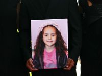Guests hold a portrait of late Palestinian girl Hind Rajab during the red carpet for the movie "The Voice of Hind Rajab" presented in competition at the 82nd International Venice Film Festival, at Venice Lido on September 3, 2025. (Photo by Stefano RELLANDINI / AFP) Palestinian girl Hind Rajab