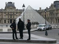 French police officers stand in front of the Louvre Museum after robbery, in Paris on October 19, 2025. Photo by DIMITAR DILKOFF / AFP Louvre Museum