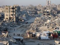 Palestinians walk past the rubble of destroyed buildings in the Sheikh Radwan neighborhood of Gaza City on October 22, 2025. Gaza rubble to be transformed into island