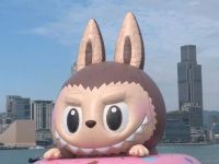 A giant inflatable Labubu floats on Hong Kong's Victoria Harbour as part of a new installation. Tourists and locals alike snap selfies at a media preview with the elf-like creature that has taken the world by storm, causing Chinese maker Pop Mart's profits to soar. (Video by AFP) Labubu