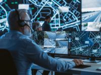 Technical Customer Support Specialist is Talking on a Headset while Working on a Computer in a Call Center Control Room Filled Display Screens with Monitoring Software. Over the Shoulder Footage (Shutterstock ) Technical Customer Support Specialist is Talking on a Headset while Working on a Computer in a Call Center Control Room Filled Display Screens with Monitoring Software. Over the Shoulder Footage