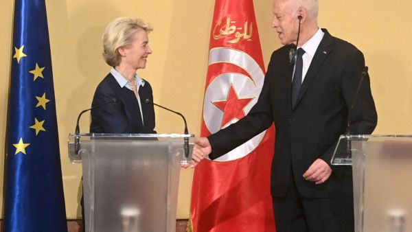 This handout picture provided by the Tunisian Presidency Press Service shows European Commission President Ursula Von der Leyen shakes the hand of Tunisia's President Kais Saied after a press briefing at the presidential palace in Tunis on July 16, 2023. (Photo by Tunisian Presidency / AFP)  Tunisia
