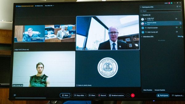 A screen shows Tyler Robinson (bottom left), the suspect in the killing of political activist Charlie Kirk, as he attends a court appearance remotely from his jail cell in Provo, Utah, on September 16, 2025. (Photo by POOL / AFP) Tyler Robinson