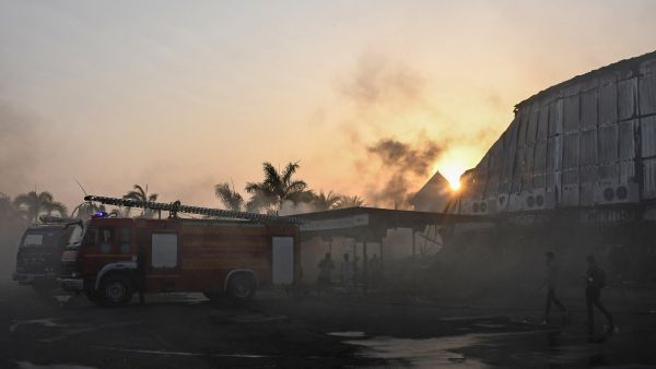Firefighters try to extinguish a fire which broke out at an amusement park facility in Rajkot, in India's Gujarat state on May 25, 2024. AFP Large grass fire engulfs abandoned Rajkot airport in western India