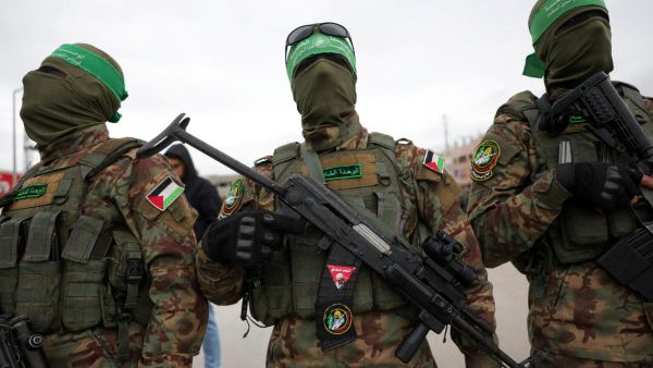 Palestinian Hamas fighters gather at the site of the handing over of Israeli hostages at the Nuseirat refugee camp in the central Gaza Strip as part of the seventh hostage-prisoner release on February 22, 2025. Photo by BASHAR TALEB / AFP Palestinian Hamas fighters