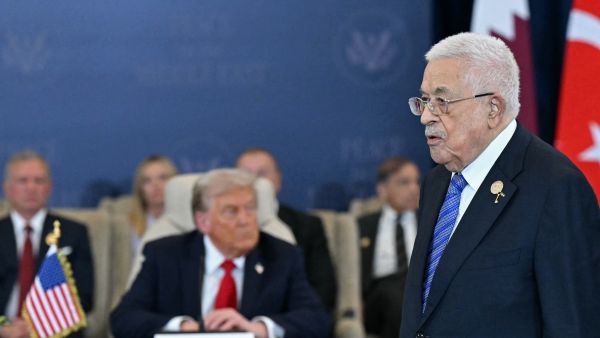 Photo by SAUL LOEB / AFP Palestinian President Mahmud Abbas (R) walks past US President Donald Trump during a summit on Gaza in Sharm el-Sheikh on October 13, 2025. Abbas issues new decree outlining presidential succession in Palestine