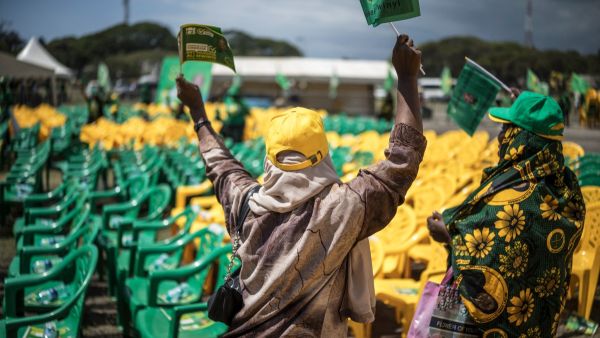 Supporters of Zanzibar incumbent President Hussein Ali Mwinyi of the ruling Chama Cha Mapinduzi (Revolutionary Party) wave flags during the campaign closing rally in Stone Town, on October 26, 2025. (Photo by MARCO LONGARI / AFP) Tanzania protests