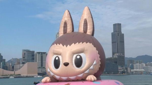 A giant inflatable Labubu floats on Hong Kong's Victoria Harbour as part of a new installation. Tourists and locals alike snap selfies at a media preview with the elf-like creature that has taken the world by storm, causing Chinese maker Pop Mart's profits to soar. (Video by AFP) Labubu